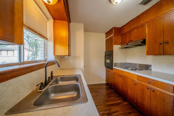 a kitchen with a sink and a large window
