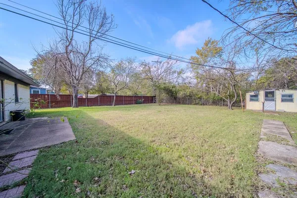 a view of a backyard with large trees