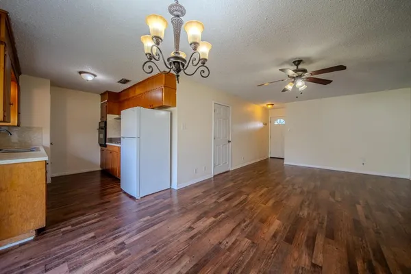a view of a room with wooden floor