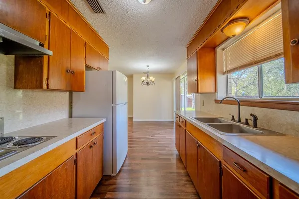 a kitchen with stainless steel appliances granite countertop a sink and a stove