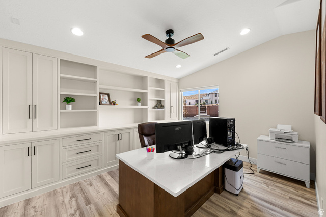 2591 East Washington Dam Road Washington, UT 84780 - Photo 29 of 67 Dedicated office space featuring extensive built-in cabinetry, integrated shelving, wood-finish flooring, a vaulted ceiling, and recessed lighting
