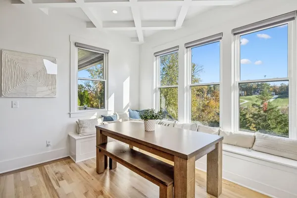 a living room with a window and a table