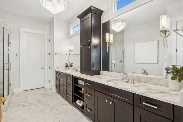 a spacious bathroom with a granite countertop sink a mirror and a shower