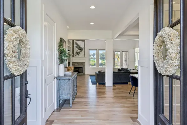 a view of living room kitchen and entryway with wooden floor