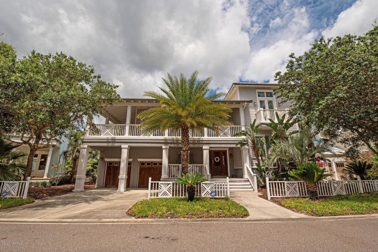 front view of a brick house with a yard