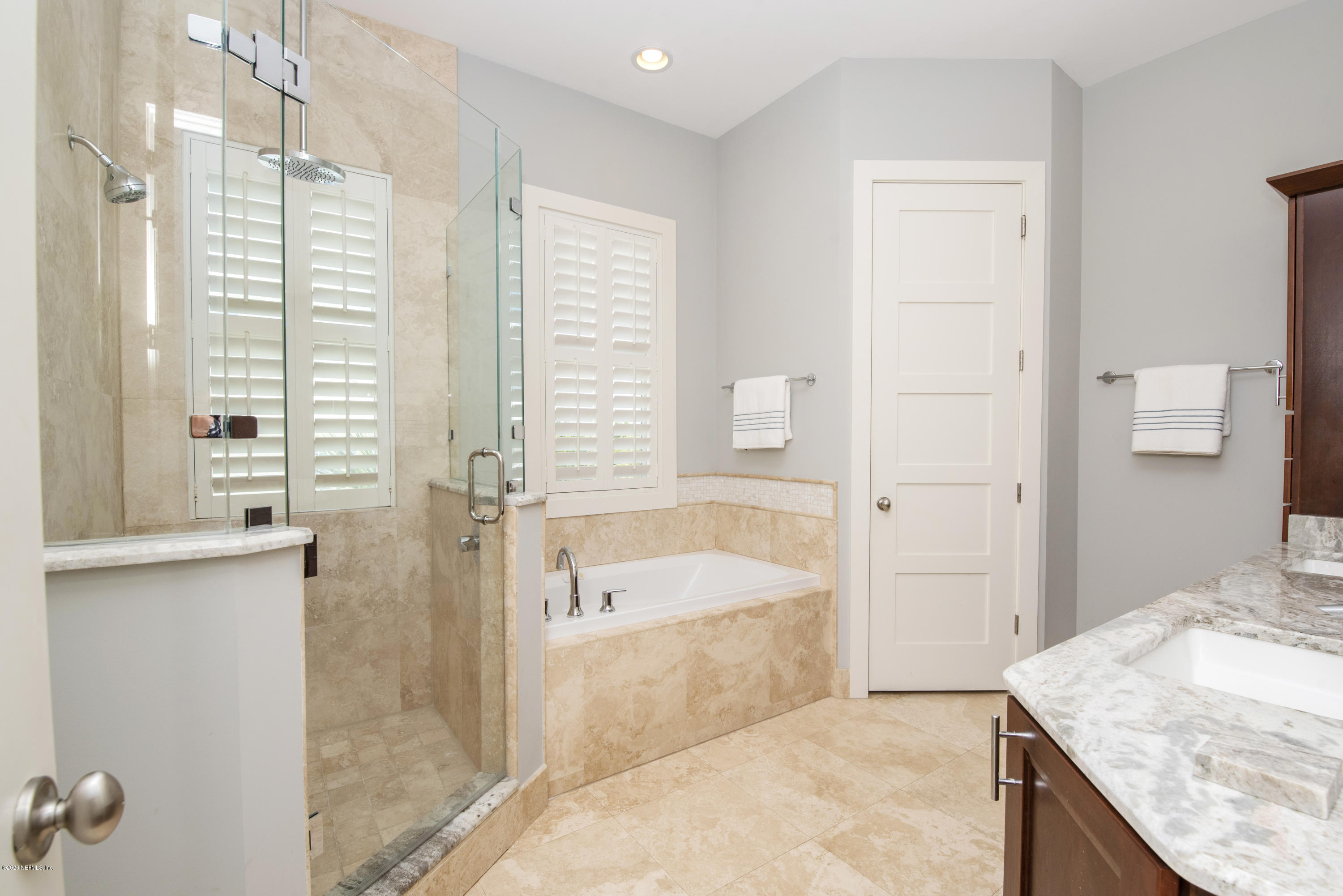 529 Barefoot Trace Circle St. Augustine, FL 32080 - Photo 27 of 62 a bathroom with a granite countertop sink a bathtub and window