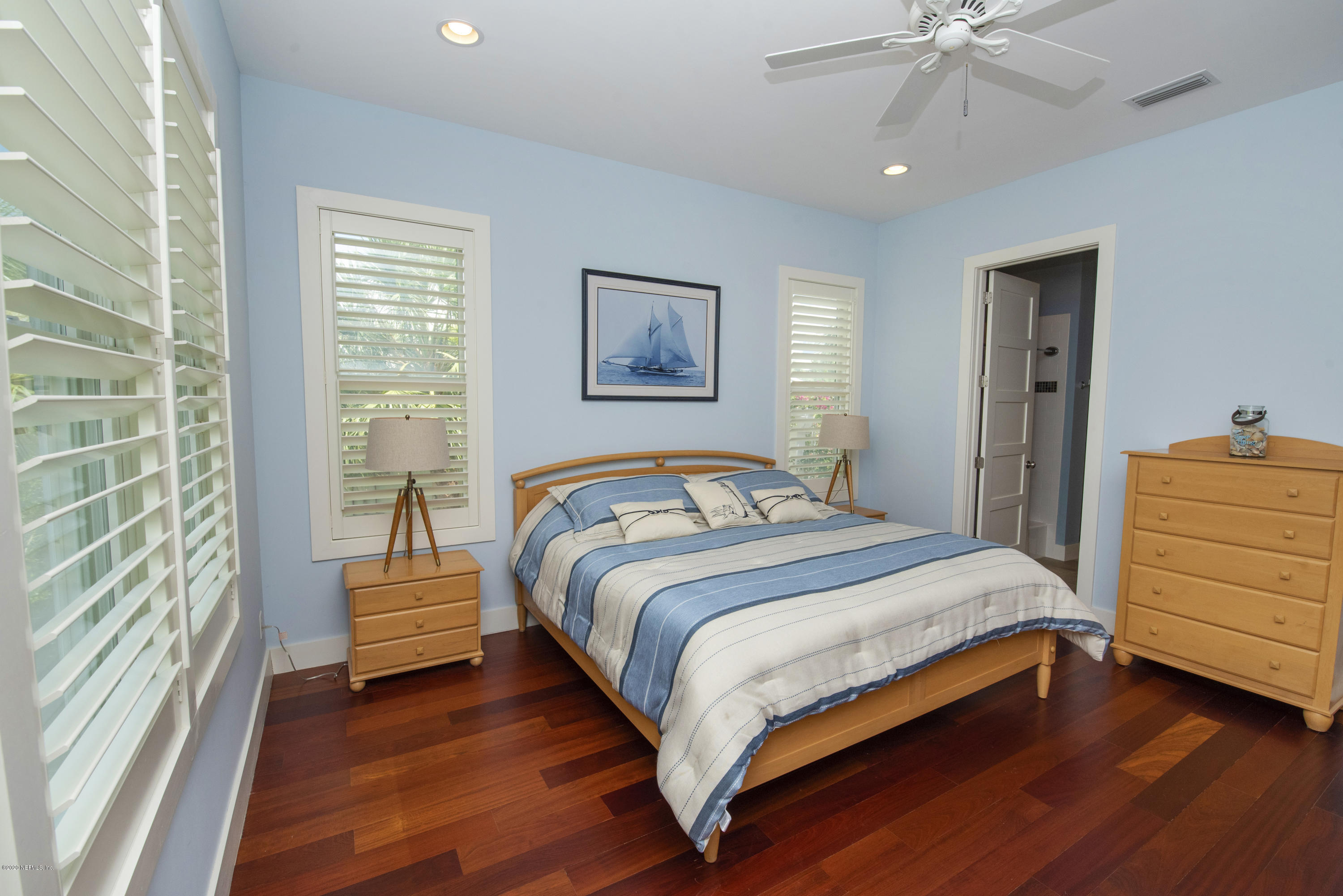 529 Barefoot Trace Circle St. Augustine, FL 32080 - Photo 31 of 62 a bedroom with a bed and a chandelier