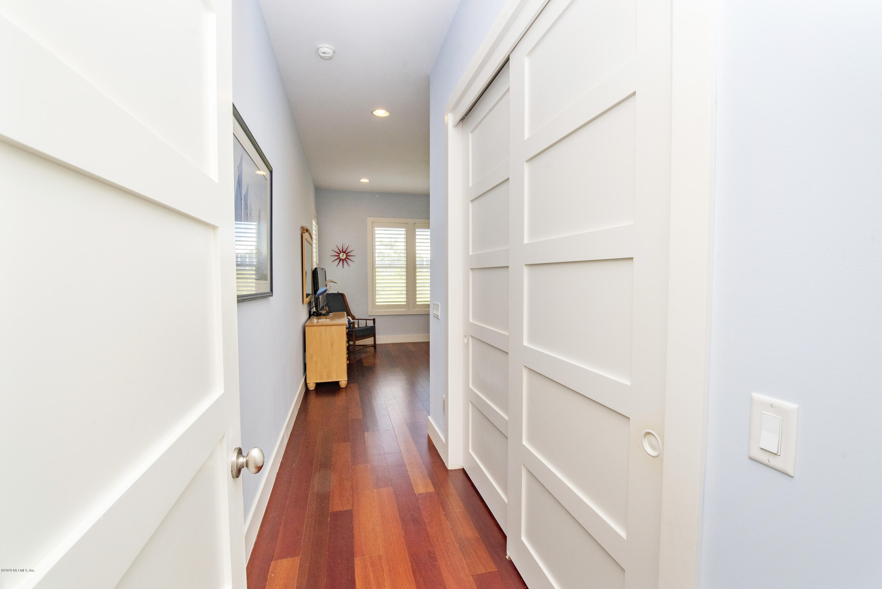 529 Barefoot Trace Circle St. Augustine, FL 32080 - Photo 35 of 62 a hallway with a white cabinets and wooden floor