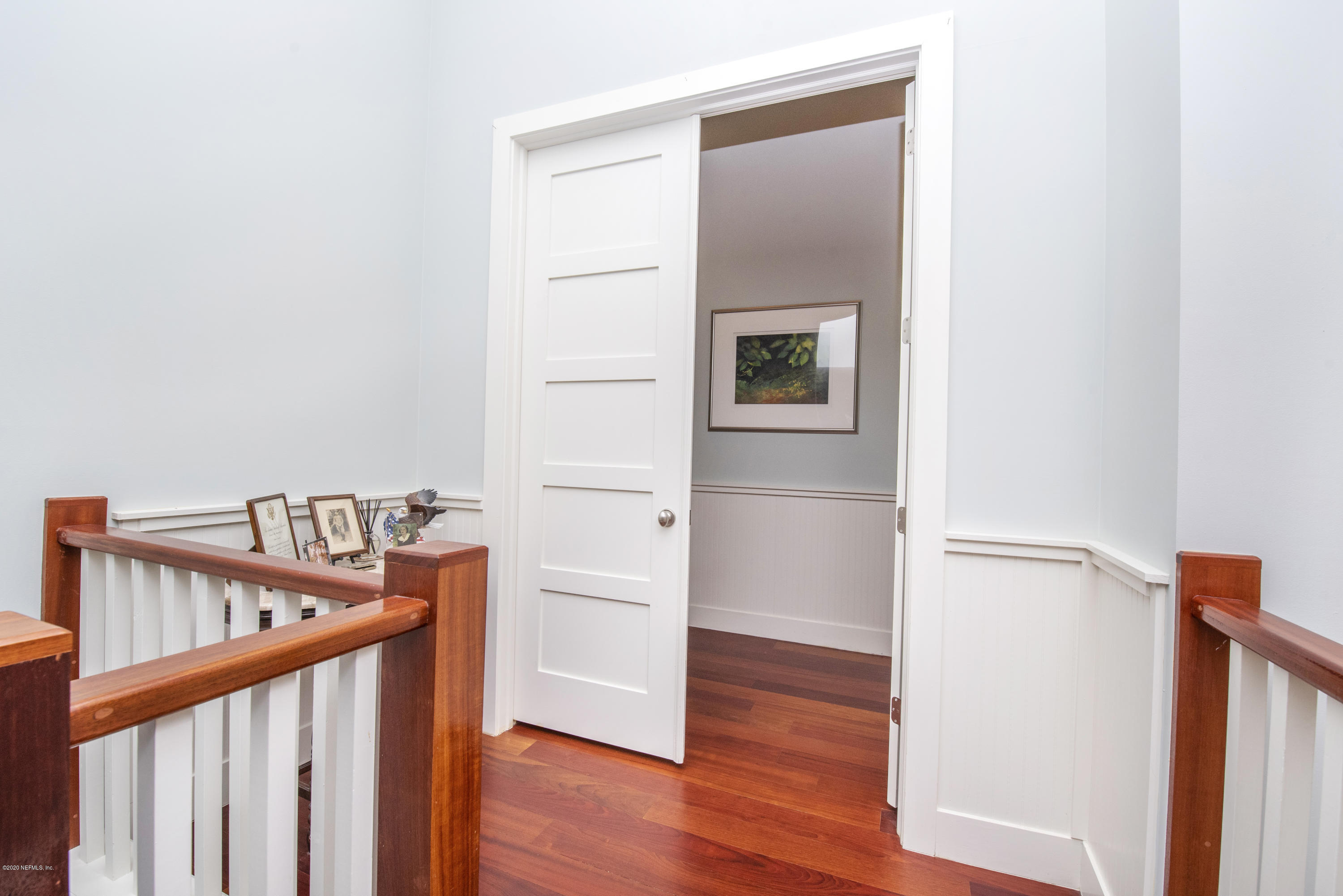 529 Barefoot Trace Circle St. Augustine, FL 32080 - Photo 41 of 62 a view of a hallway with wooden floor and stairs