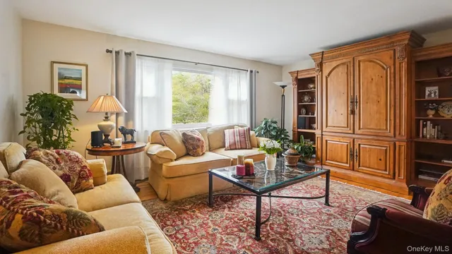 a living room with furniture fireplace and a large window