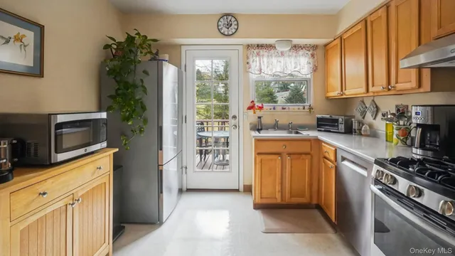 a kitchen with stainless steel appliances a stove a sink and a refrigerator