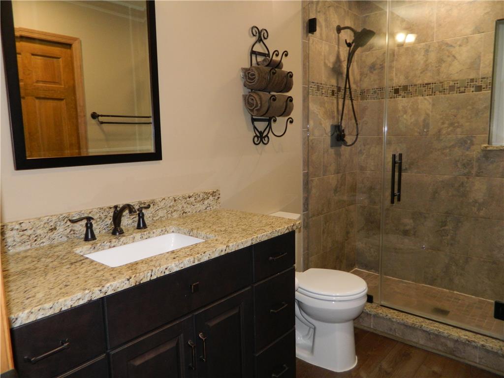 328 Pin Oak Road Stroudsburg, PA 18360 - Photo 27 of 37 A refined bathroom featuring a granite vanity and a spacious, tiled shower enclosure.