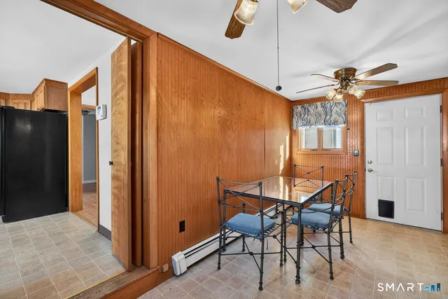 a view of a dining room with furniture and a chandelier