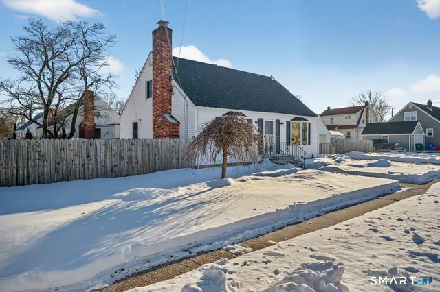 a view of a house with snow on the road