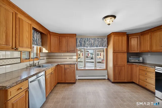 a kitchen with granite countertop a refrigerator and stove