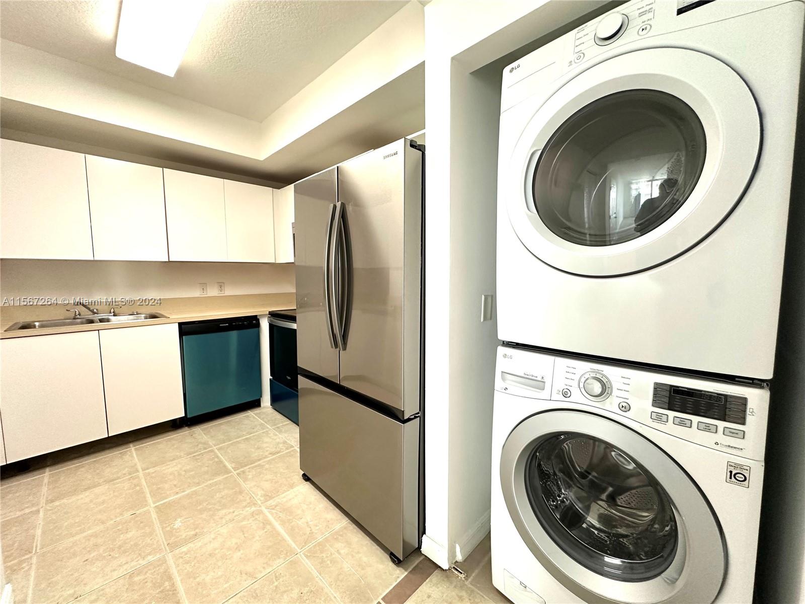 a view of a kitchen with a washer and dryer