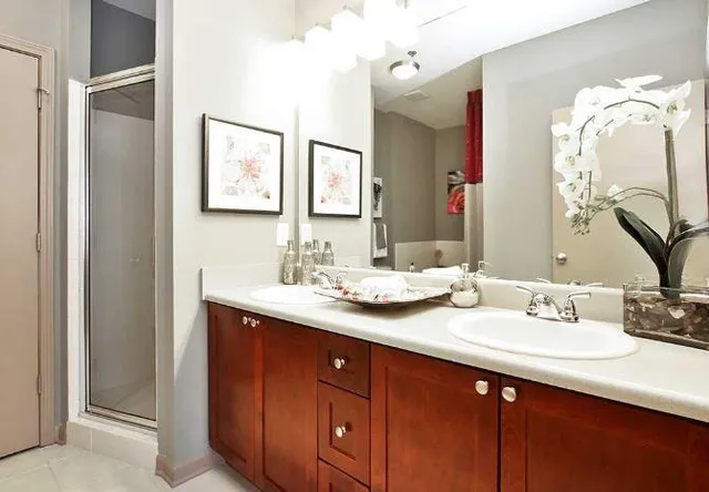 a bathroom with a double vanity sink and a mirror