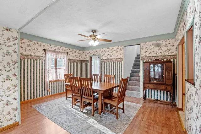 a view of a dining room with furniture window and wooden floor