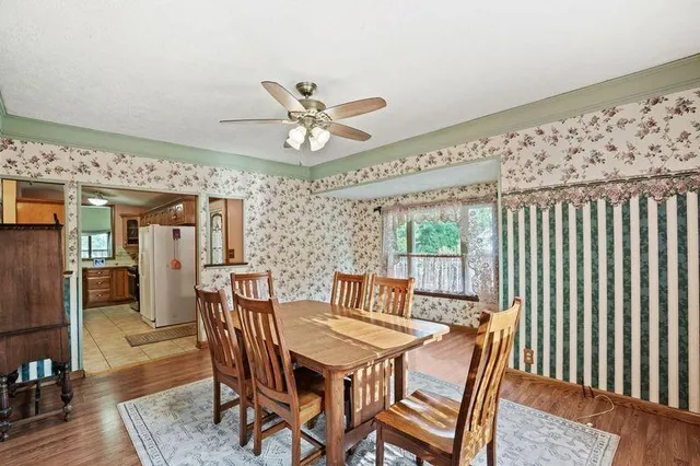 a view of a dining room with furniture window and wooden floor
