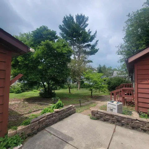 a backyard of a house with a garden and plants