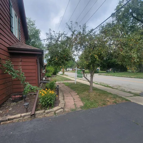 a view of a street with a house in the background