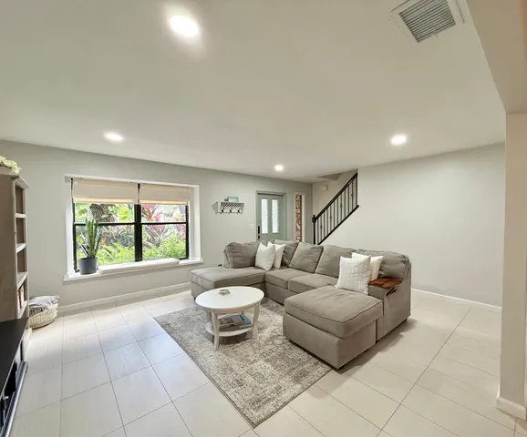 a living room with furniture and a large window