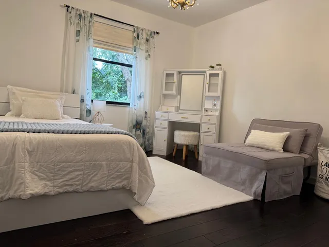 a bed sitting in a bedroom next to a window