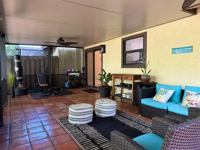 a outdoor living space with furniture and a rug