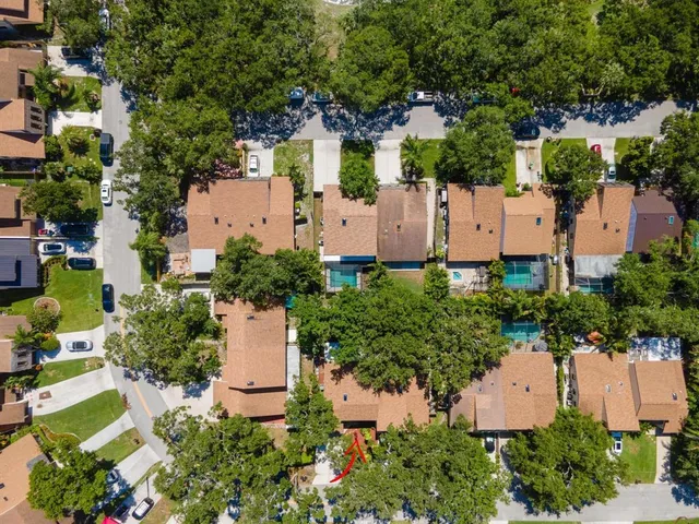 an aerial view of a house with a yard and garden