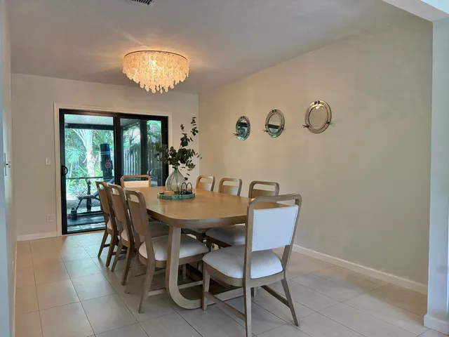 a view of a dining room with furniture and chandelier