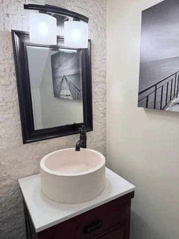 a bathroom with a sink and mirror