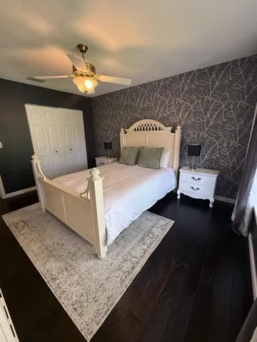 a bed sitting in a room next to a lamp