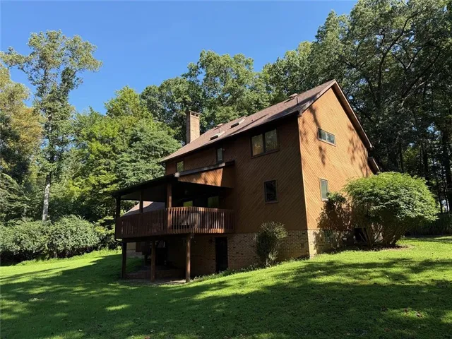 a view of a big yard with large trees