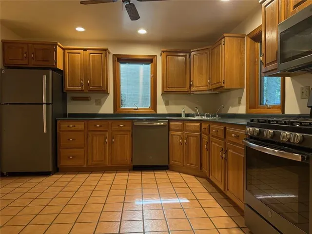 a kitchen with a sink a stove and cabinets