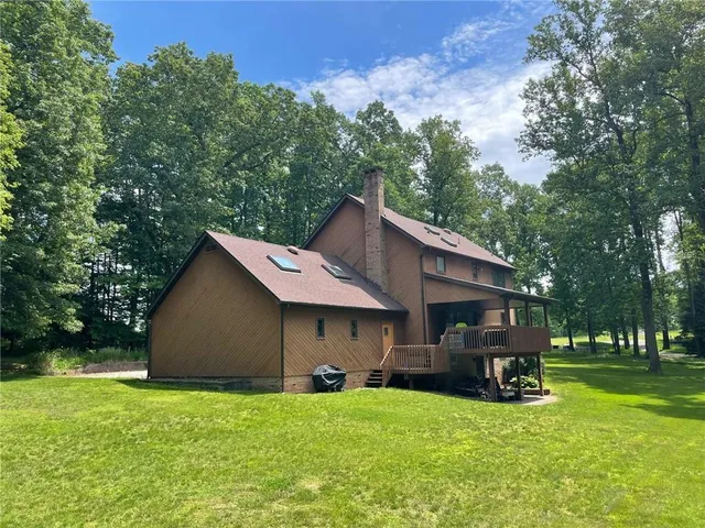 a view of a house with a yard and sitting area