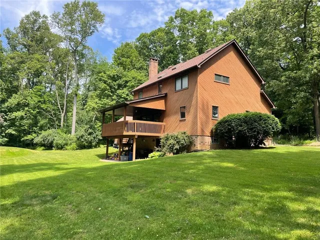 a view of a house with a yard and sitting area