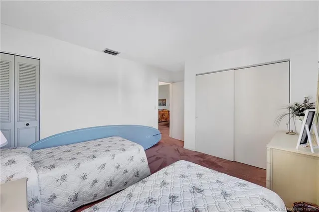 a bedroom with a bed and a view of bathroom