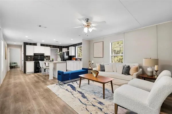 a living room with furniture and kitchen view