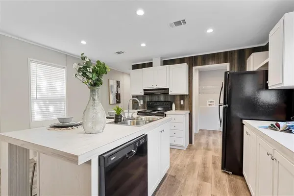 a kitchen with a refrigerator and a microwave