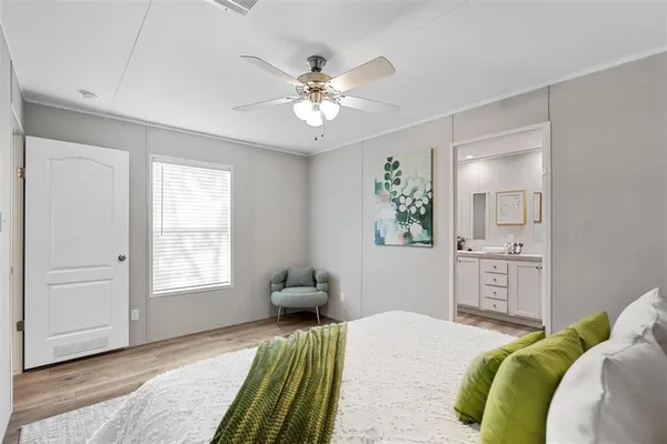 a bedroom with a bed dresser and a window