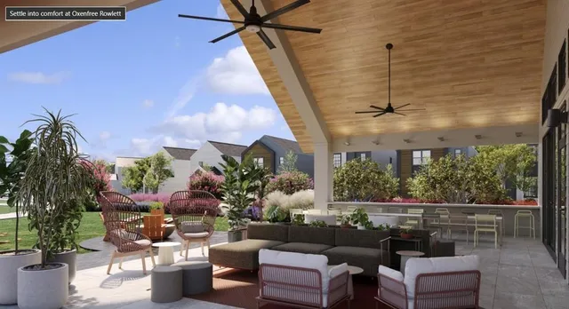 a view of a house with backyard and sitting area