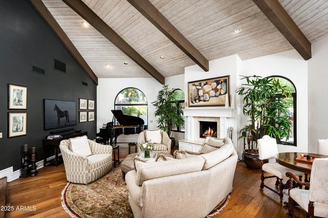 a living room with furniture and a floor to ceiling window