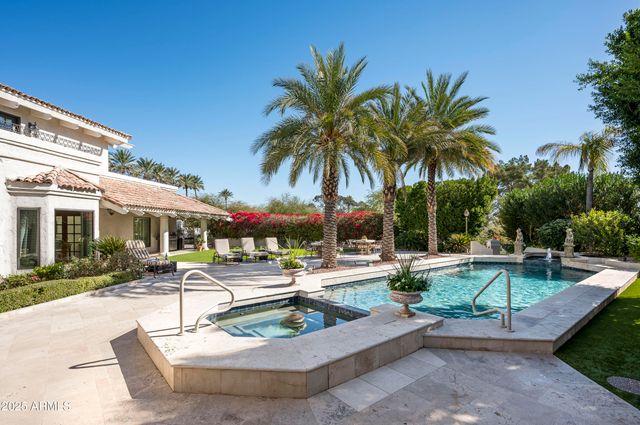 a view of an outdoor dining space with a table and chairs