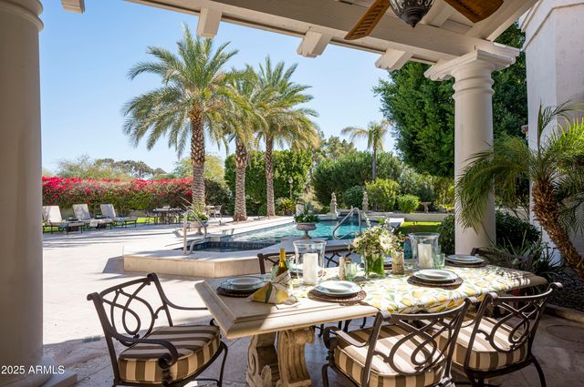 a dining room with furniture a chandelier and wooden floor