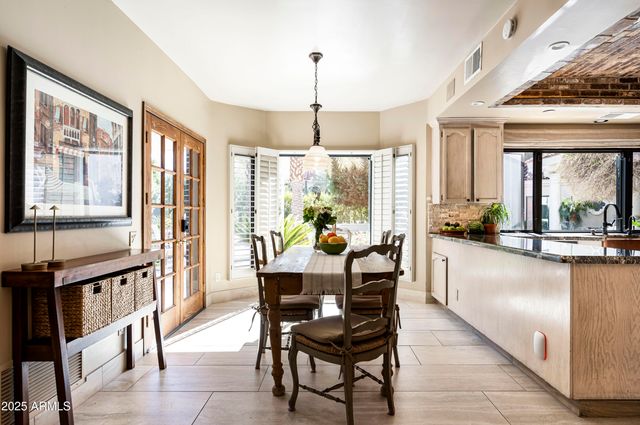a view of a dining room with furniture large windows and wooden floor