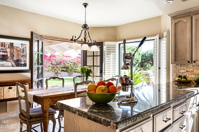 a kitchen with a sink appliances and cabinets