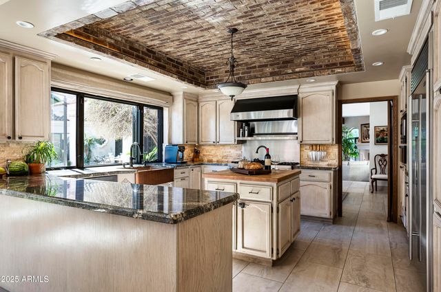 a bedroom with a bed a dresser next to a window