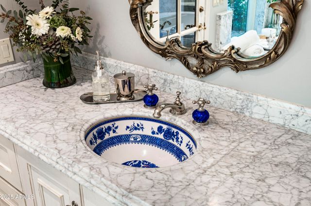 a living room with a large window and a wooden floor