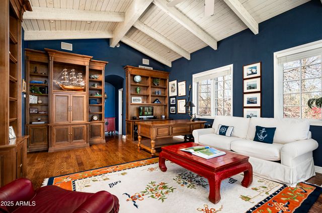a view of roof deck with furniture and trees