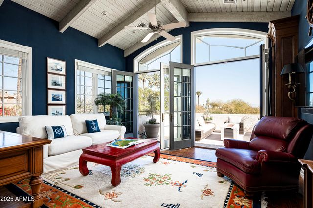 a living room with furniture a table and a large window